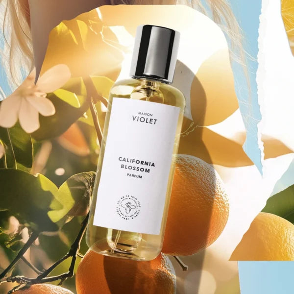 California Blossom by Maison Violet perfume bottle with oranges and flowers in artistic composition