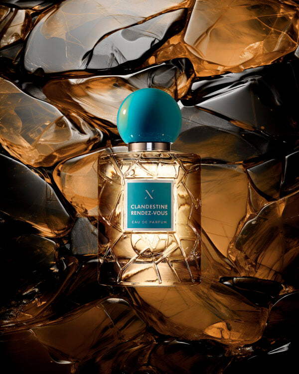 Clandestine Rendez-Vous Eau de Parfum by Les Sœurs de Noé luxury fragrance bottle with turquoise cap against warm amber crystal background