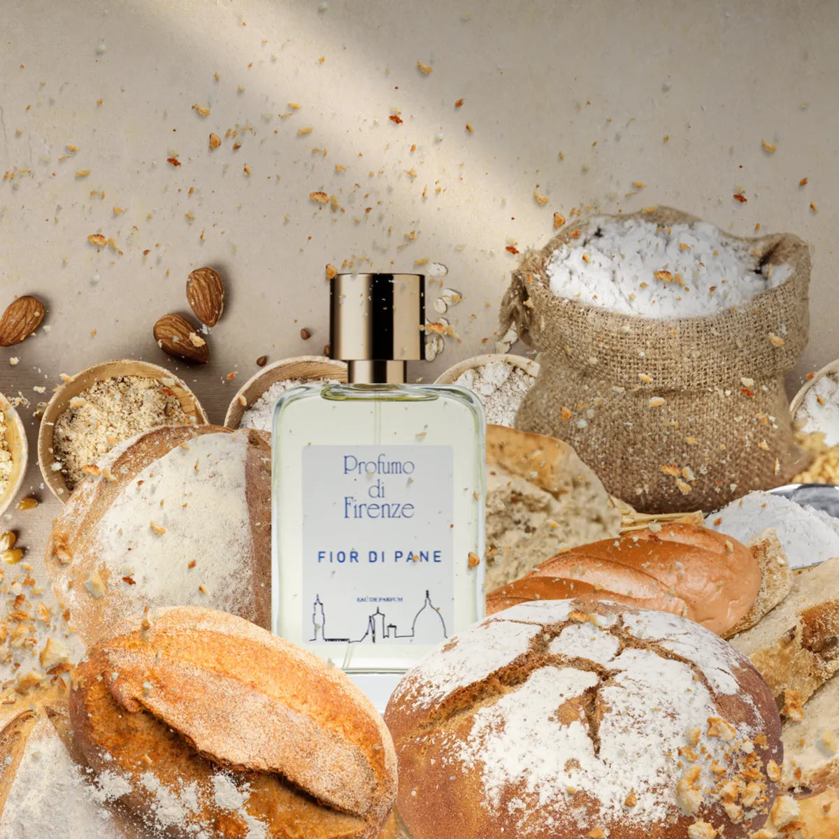 Perfume bottle labeled 'Fior di Pane' surrounded by bread and ingredients on a textured surface