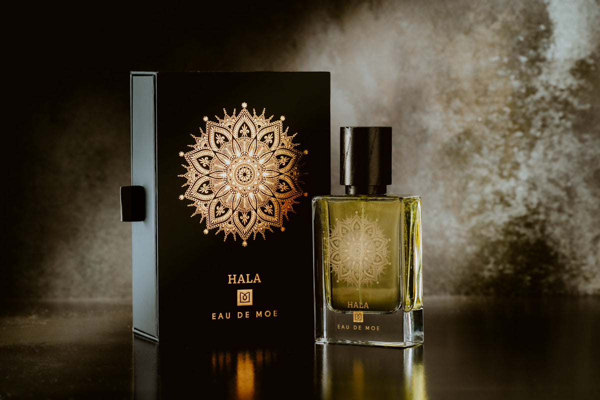 Hala Eau de Moe perfume bottle and packaging on a dark background