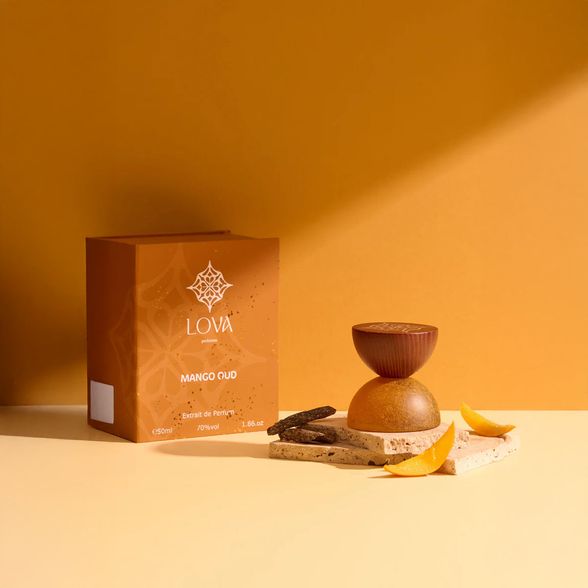 Mango Oud by LOVA Extrait de Parfum 50ml with textured golden bottle and branded box styled with mango slices and oud wood in warm luxury setting