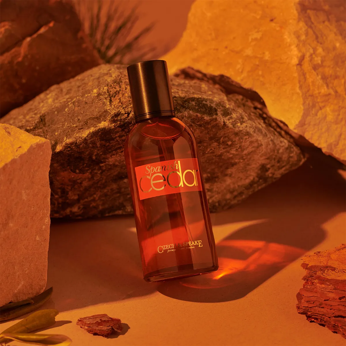 Czech & Speake Spanish Cedar perfume bottle displayed among warm-toned rocks, luxury woody fragrance inspired by rich Spanish cedarwood scent, elegant niche perfume from London