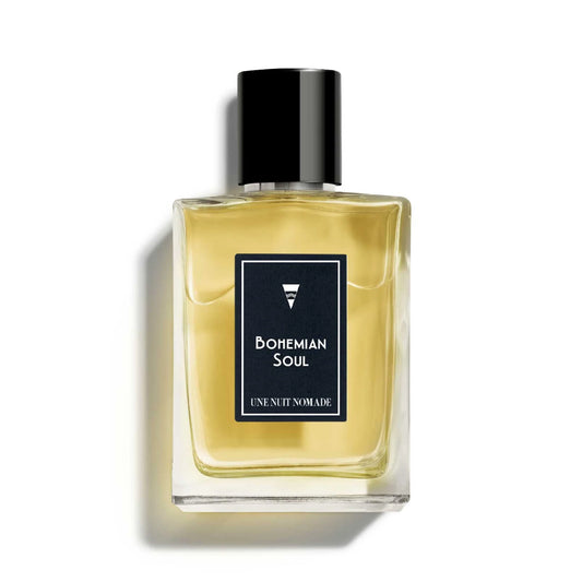 Une Nuit Nomade Bohemian Soul perfume in clear glass bottle with black cap, niche fragrance inspired by free-spirited bohemian elegance with warm woody, spicy, and sensual aromatic notes