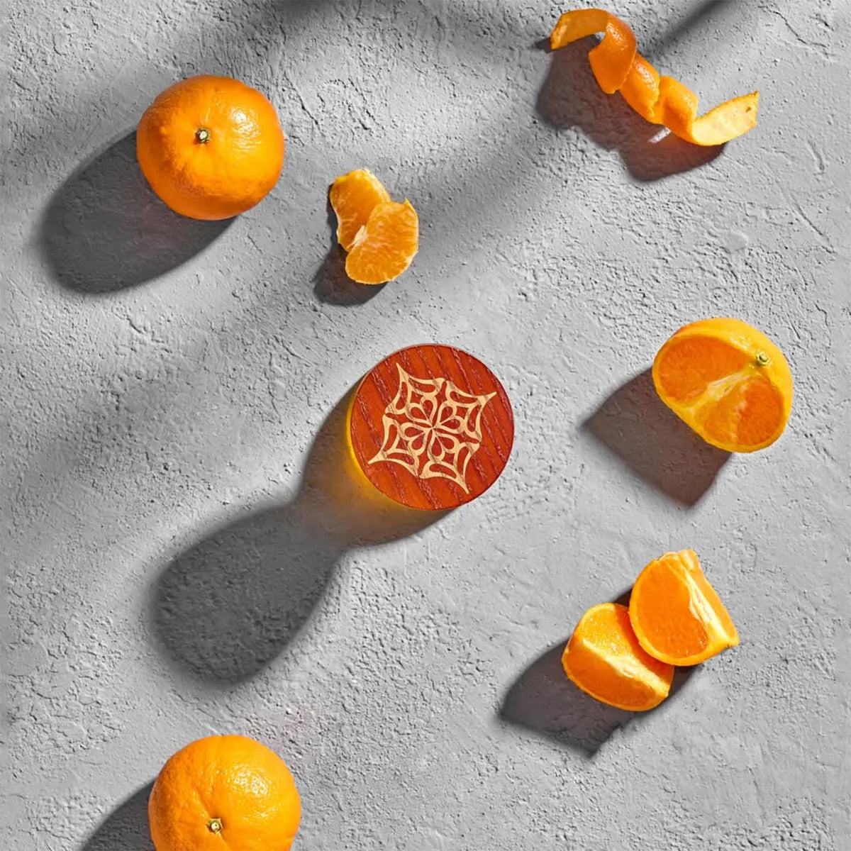 Cheerful Mandarin by LOVA perfume cap detail surrounded by fresh mandarin slices on textured grey background