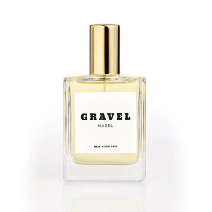 Hazel by GRAVEL niche perfume bottle with golden cap on white background
