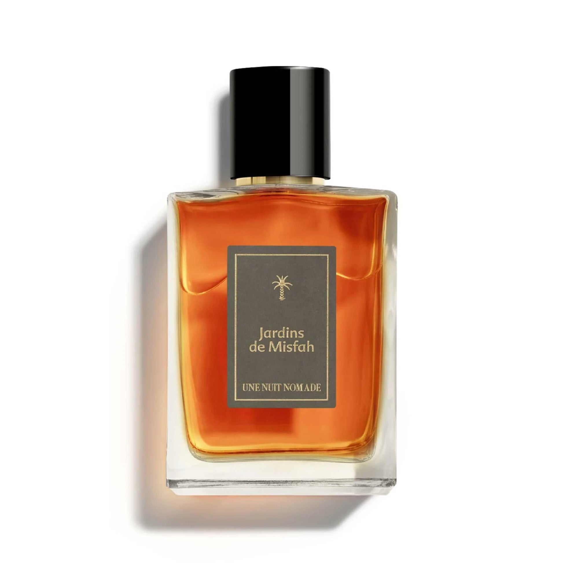 Une Nuit Nomade Jardins de Misfah Eau de Parfum in clear glass bottle with warm amber fragrance, niche perfume inspired by Arabian date gardens, rich gourmand sweetness, and oriental woody elegance