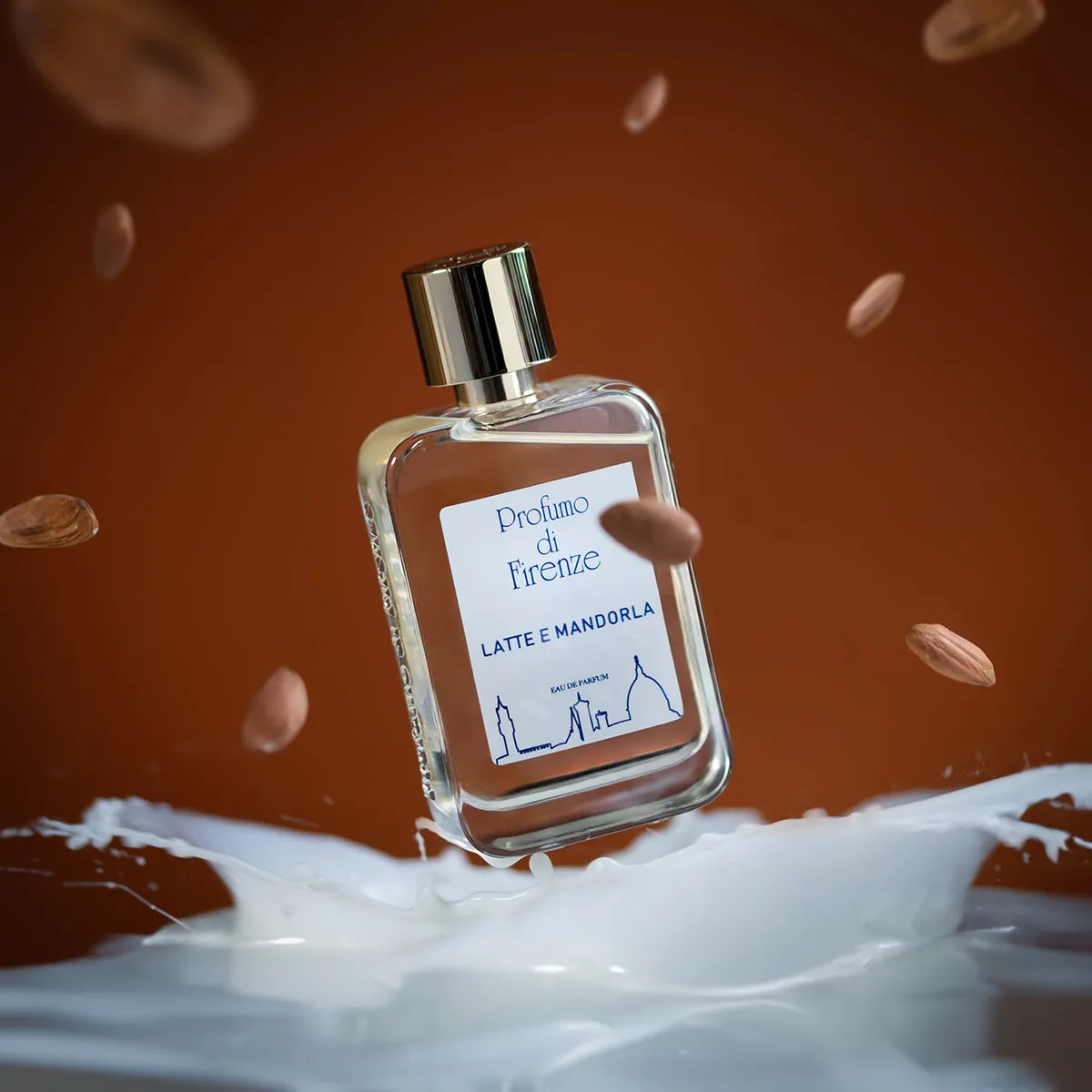 Perfume bottle labeled 'Proflume di Firenze' with掉落的nuts on a brown background