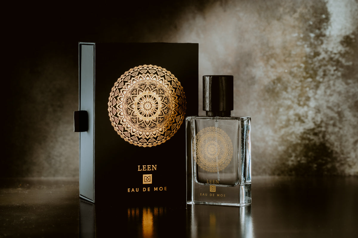 Leen by Eau De Moe perfume bottle with gold mandala detailing displayed beside matching black luxury box packaging