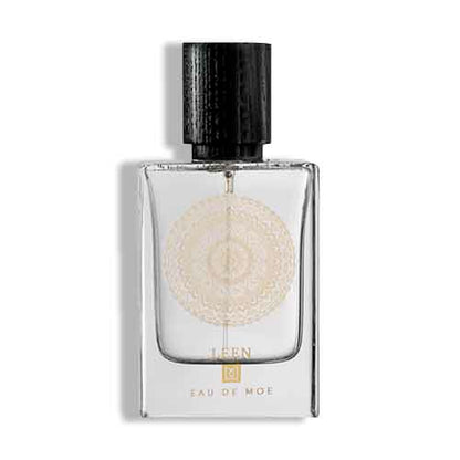 Leen Eau De Moe perfume bottle with transparent glass, gold mandala emblem, and black textured wooden cap