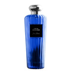 Blue perfume bottle with silver cap on a white background