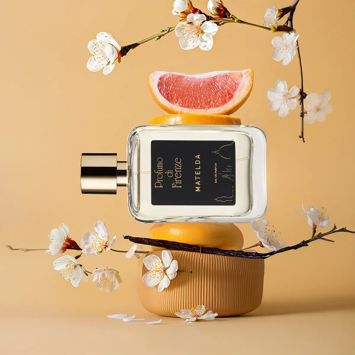Perfume bottle with floral elements on a beige background