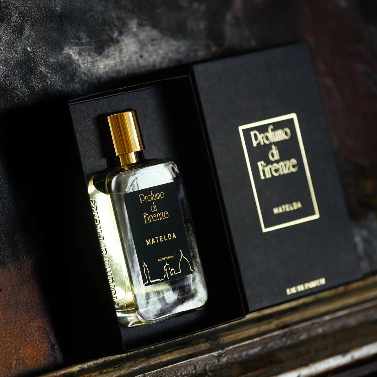 Perfume bottle and packaging of Profumo di Firenze on a dark textured surface