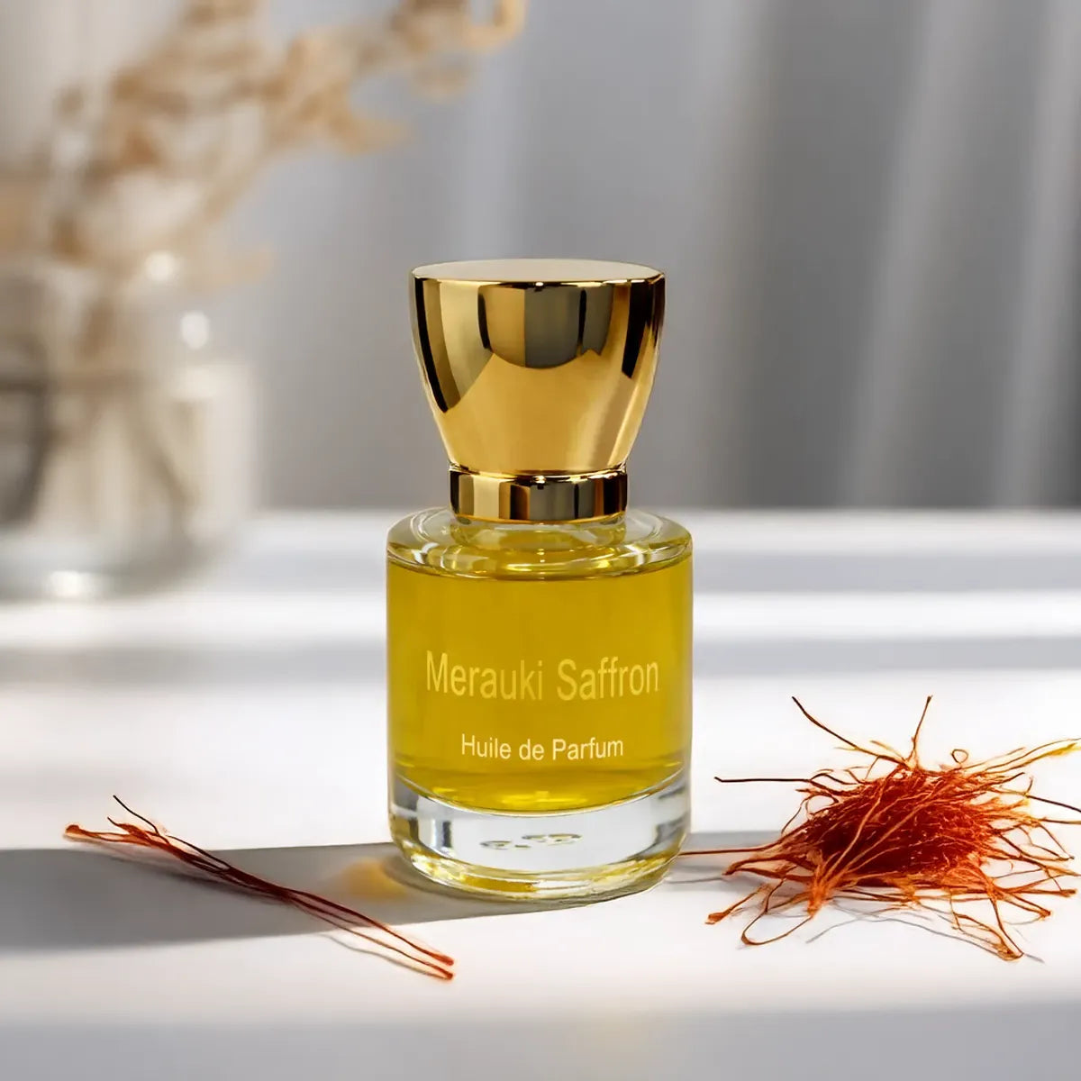 Merauki Saffron fragrance bottle displayed with delicate saffron threads on a minimal surface
