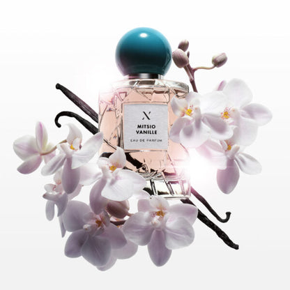 Mitsio Vanille Eau de Parfum by Les Sœurs de Noé luxury fragrance bottle with vanilla pods and white orchid flowers on light background