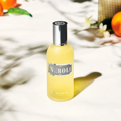 Yellow bottle labeled 'Neroli' with a silver cap on a light background
