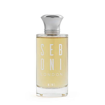 Seboni London Nine eau de parfum clear glass bottle with golden liquid and silver cap on white background