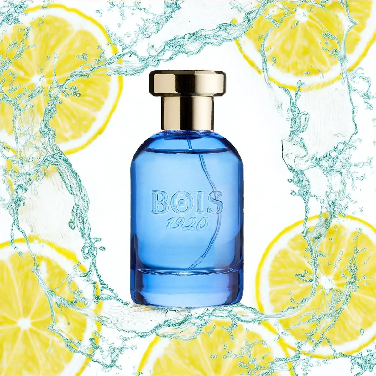 Bois 1920 Oltremare Eau de Parfum blue glass bottle with gold cap surrounded by splashing water and fresh lemon slices, evoking a vibrant citrus aquatic fragrance