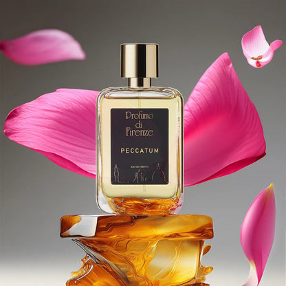 Perfume bottle labeled 'Peccatum' by 'Profumo di Firenze' with pink petals on a reflective surface.