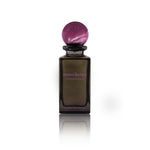 Pheromones by Reinvented Extrait de Parfum bottle with purple marble cap on white background
