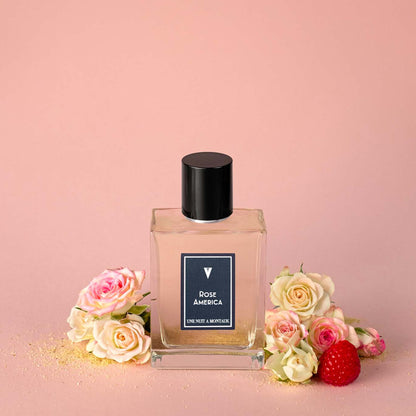 Une Nuit Nomade Rose America Eau de Parfum bottle with blooming roses and raspberry, niche fragrance inspired by fresh rose petals, soft florals, and delicate fruity floral elegance