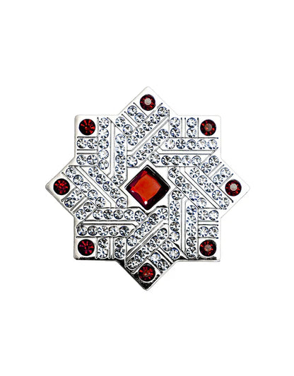 Ruby by Kajal perfume cap close-up with silver star design, red gemstone center and crystal embellishments