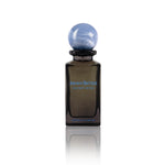 Sacred Bond by Reinvented Extrait de Parfum bottle with blue marble cap on white background
