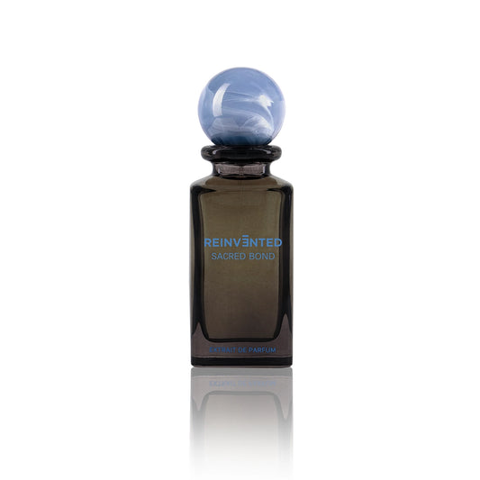 Sacred Bond by Reinvented Extrait de Parfum bottle with blue marble cap on white background
