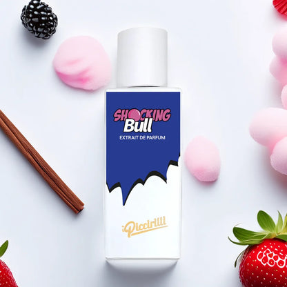 Shocking Bull Extrait de Parfum by iPiccirilli fragrance bottle surrounded by strawberry, blackberry, cinnamon stick, and pink candy elements