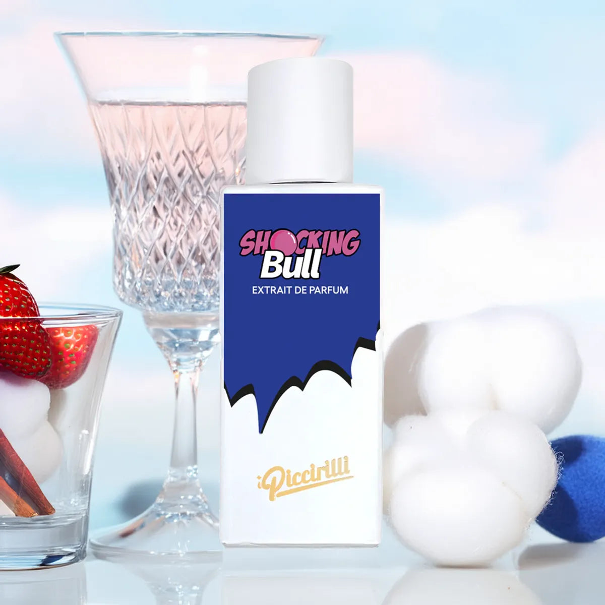 Perfume bottle labeled 'SHOCKING Bull' with a glass of strawberries and ice cubes in the background.