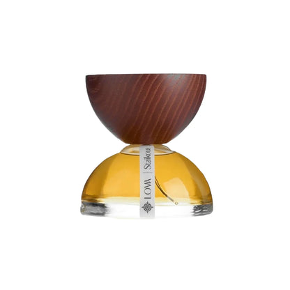 Staikous by LOVA niche perfume bottle with golden glass base and handcrafted wooden cap on clean white background
