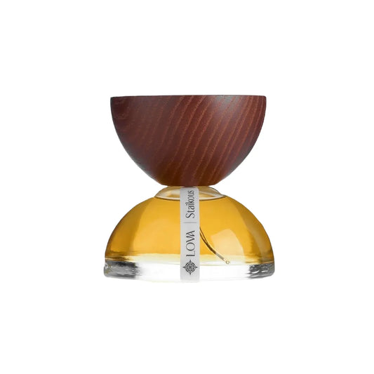 Staikous by LOVA niche perfume bottle with golden glass base and handcrafted wooden cap on clean white background