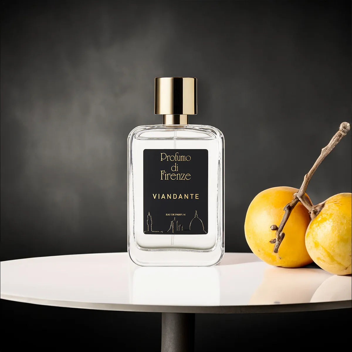Perfume bottle labeled 'Profumo di Firenze Viandante' on a white surface with yellow fruits.